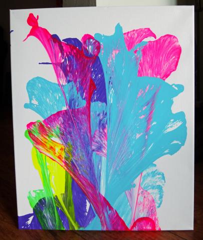 Vibrant blue, pink and yellow paint splashed across a white background. 