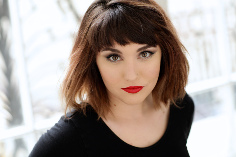 Photo of Jessy Yates, a woman with brown, shoulder length hair and a black shirt